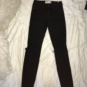 Black high rise jeans with knee rips